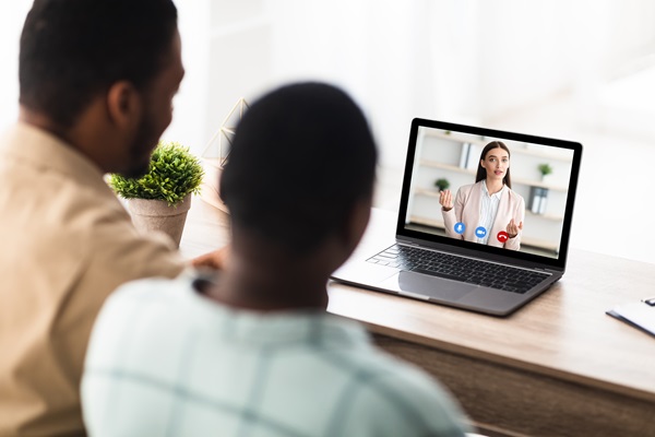 Black Couple Having Video Call Online Consultation With Manager Indoor