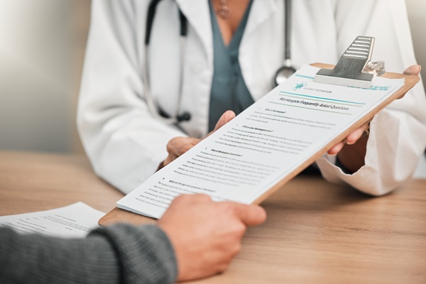 patient hands over medical form