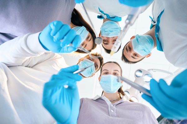 Team of young dentists with dental instruments in their hands